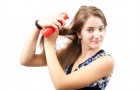 girl spraying hair over white